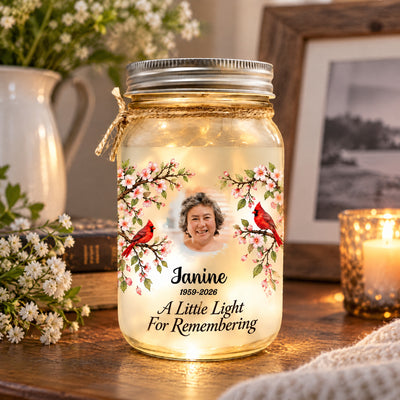 Personalized Mason Jar Light on a wooden shelf with white flowers, a candle and a framed photo