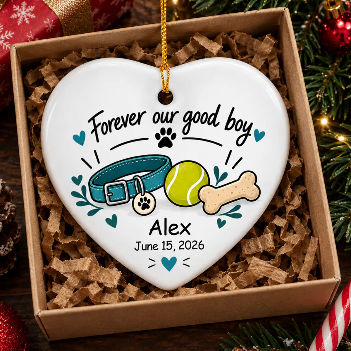 Personalized ceramic ornament Forever Our Good Boy heart resting in a kraft gift box with paper shred filling