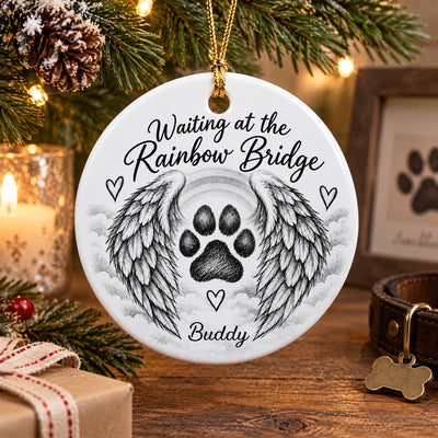 Personalized pet memorial ceramic ornament on a wood table with candle, gift box, and bone-shaped dog tag