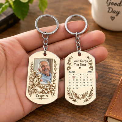 Personalized Stainless Steel Memorial Keychain held in an open hand, showing photo and angel side and March calendar side