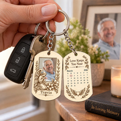 Personalized Stainless Steel Memorial Keychain clipped with a car key and fob, near a framed photo and candle