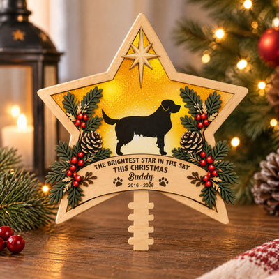 Personalized Brightest Star Christmas Tree Topper standing on a wooden table beside a lantern and candle